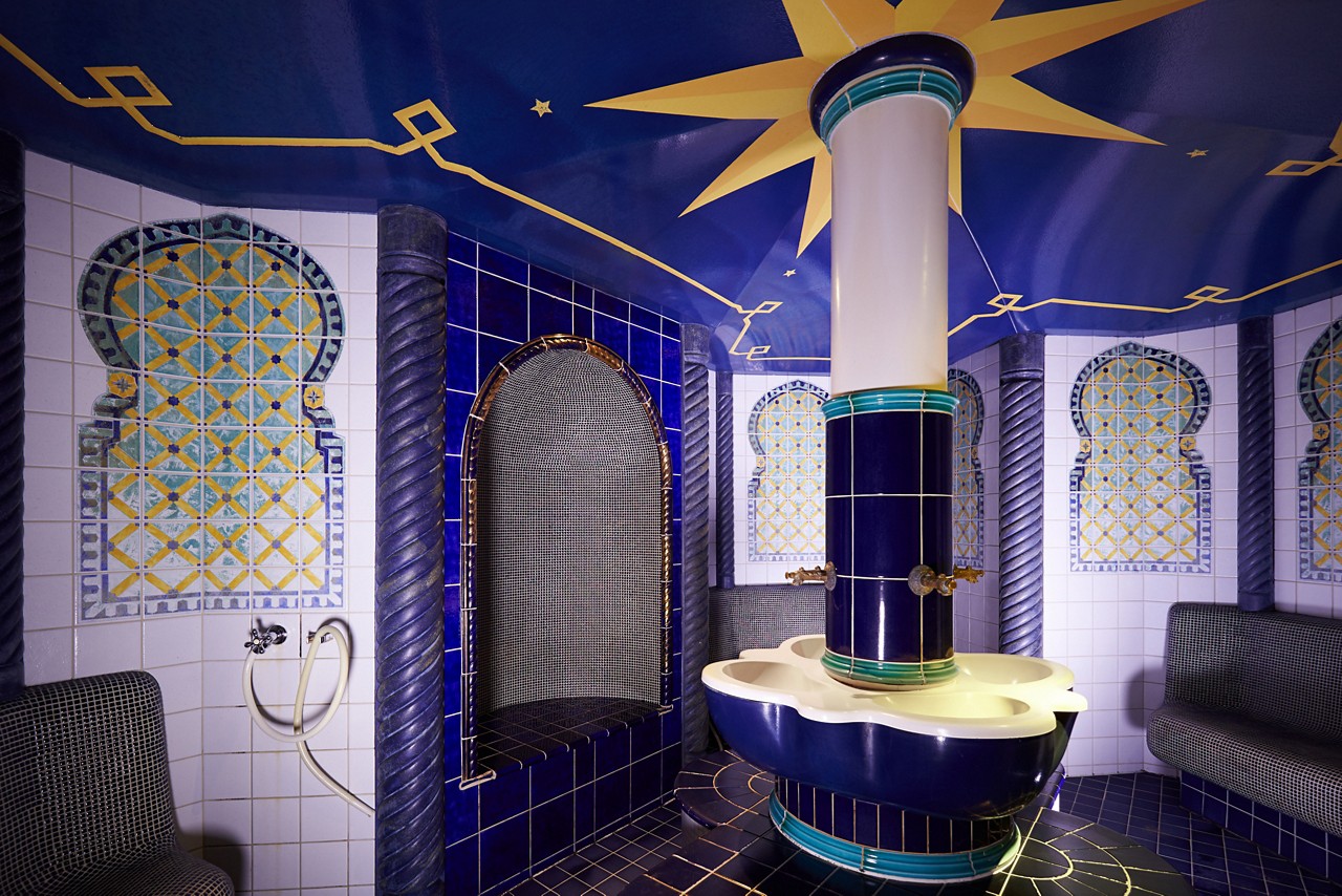 Decorative tiled Turkish Hammam with intricate designs on the walls.